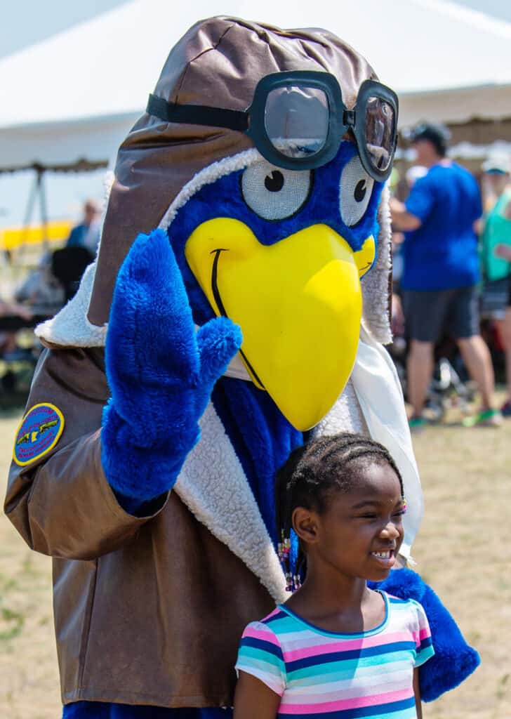 Buzz poses with a future aviator at an upcoming Wings of the North AirExpo!