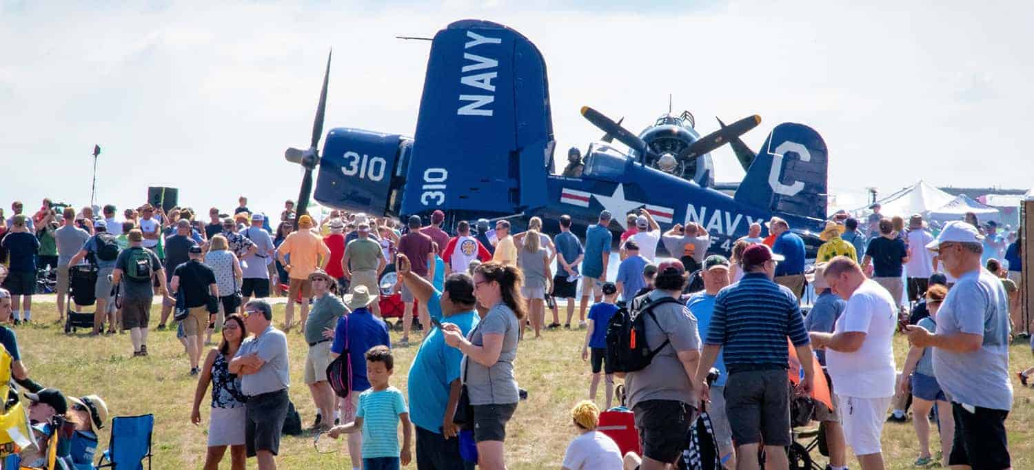 A crowd gathers by Wings of the North F4U Corsair at AirExpo21