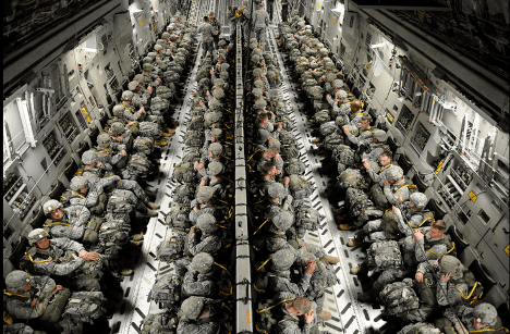 U.S. Army 82nd Airborne Division paratroopers seated in a C-17