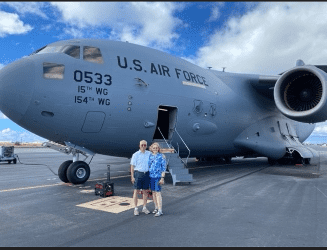 Cary and his wife standing in front of the C-17